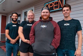 Coltin Handrahan, right, owner of Golden Custom Clothing, and his team, from left, Daniel Timen, Abby Kinch and Porter Smith, have come up with a business idea they hope will help businesses that have been shut down and artists who aren’t working or touring due to the current pandemic. They’re offering to design custom-fundraising T-shirts, sell them to Islanders for $25 and donate $10 from each sale to the business or artist to help pay for their expenses during this challenging time.