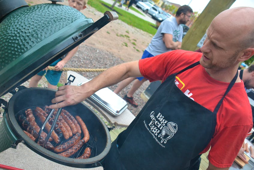 Chris Buote grills some bratwurst sausages at Founders’ Food Hall in Charlottetown on Sept. 28. The food hall’s vendors celebrated their own Oktoberfest, taking inspiration from the annual beer festival in Germany.