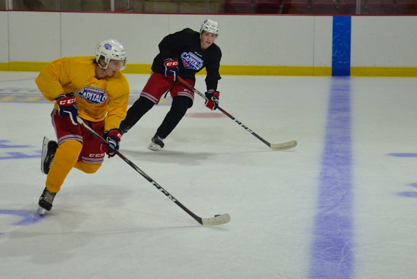 Summerside Western Capitals forward Nick Reeves, yellow jersey, and defenceman Ed McNeill work on a drill during Tuesday afternoon’s practice at Eastlink Arena. The Caps will host the Yarmouth Mariners in their home opener on Saturday at 7 p.m.