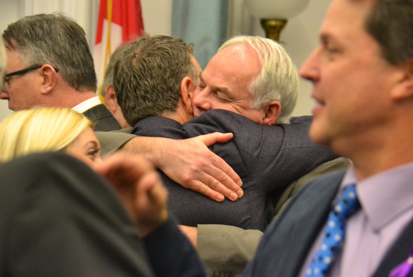 Premier Dennis King and Opposition Leader Peter Bevan-Baker share a hug following the closure of the fall session at the P.E.I. legislature on Thursday. The government passed more than 20 bills.
