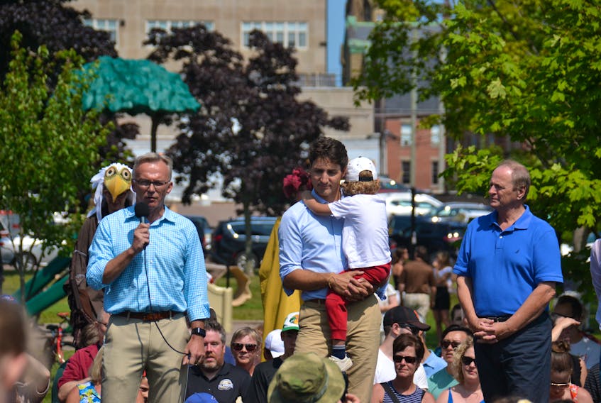 From left, Charlottetown MP Sean Casey, Prime Minister Justin Trudeau, holding his son Hadrien, and Egmont MP Bobby Morrissey are shown at an event in Charlottetown in August 2018.