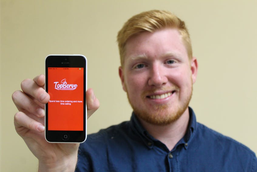 Nick Cameron showcases the TopServe app on his phone. He officially launched the service in May 2019 and has partnered with six Charlottetown restaurants.