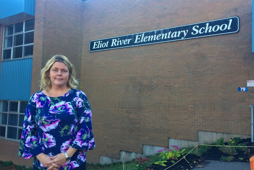 Amy MacFarlane, who is with the Eliot River School Home and School Association, is shown in front of the school, which she says is in desperate need of infrastructure upgrades.