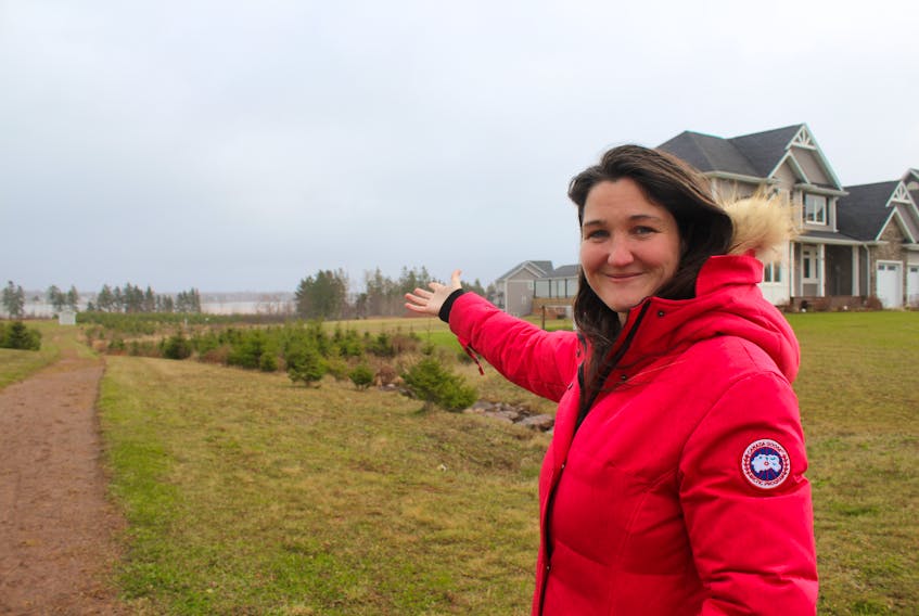 Karralee McAskill, co-ordinator with the Cornwall Area Watershed Group, shows where residents of Sunrise Cove want to take away trees to maintain their water view. McAskill says removal of the trees will have long-term ecological effects for wildlife and water in the area.