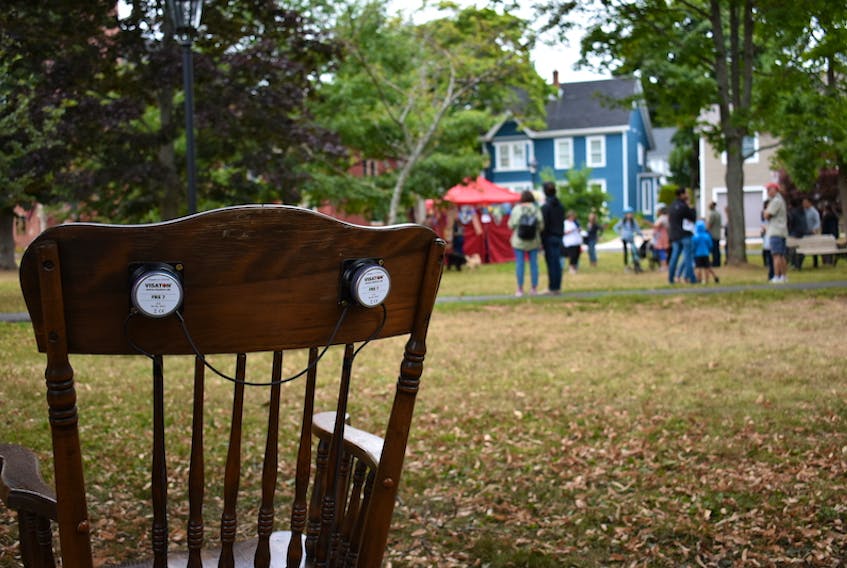 This is one of the rocking chairs set up in Rochford Square. In the background, people wait to record their own lullabies in the pop-up recording studio.