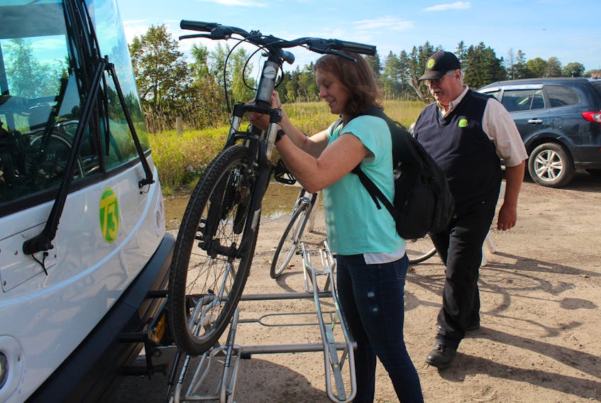Ruth Cox places her bike on a T3 Transit bus bike rack (with Ivan Proude’s instruction) as a part of the a demonstration that took place outside the Charlottetown Farmer’s Market on Saturday, Sept. 28.