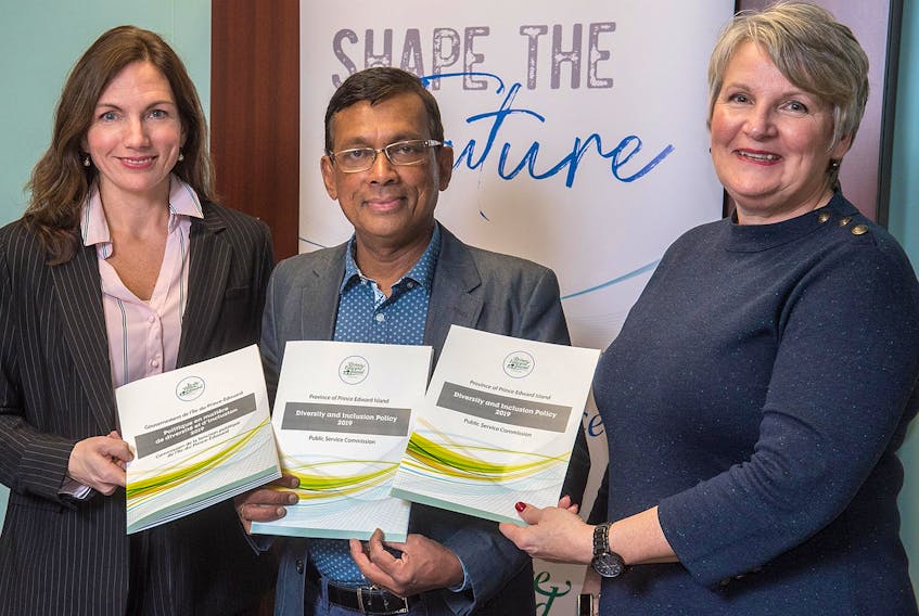 Tanya Rowell, CEO of the Public Service Commission, and Thilak Tennekone, diversity consultant, stand with Minister of Finance Darlene Compton to present the new Diversity and Inclusion Policy released by the Public Service Commission.