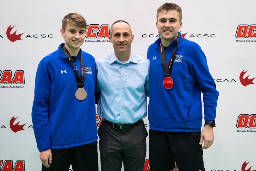 Canadian Collegiate Athletic Association (CCAA) badminton convenor Michael Kopinak, centre, congratulates Charlottetown’s Jack Ronahan, left, and his doubles partner, Bryce Mason, after they recently captured the silver medal at the national championships in Toronto.