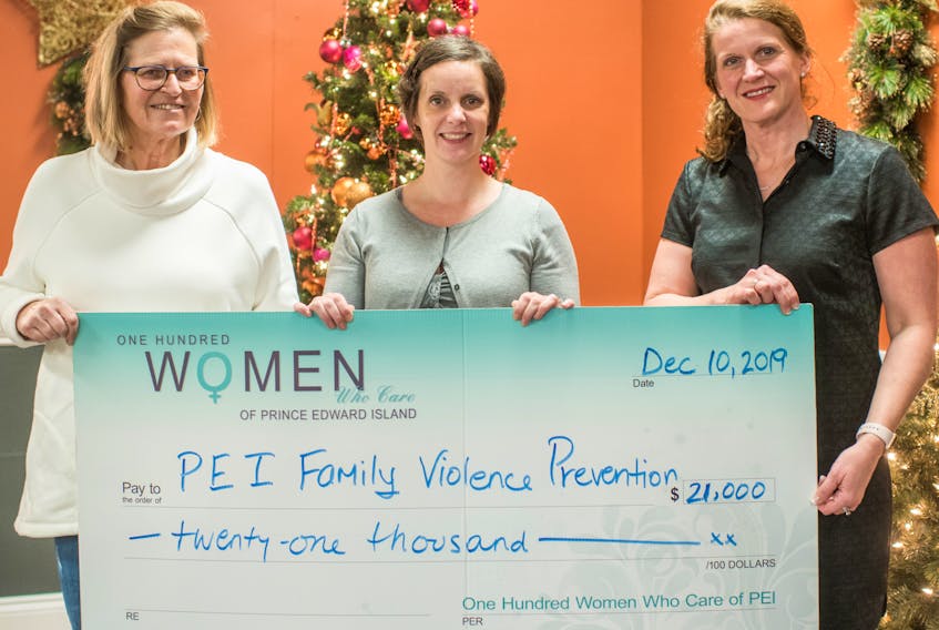 Debbie Miller, left, of P.E.I.’s 100 Women Who Care chapter, along with fellow member Cheryl Paynter, right, present a cheque to Danya O’Malley, executive director of P.E.I. Family Violence Prevention Services.