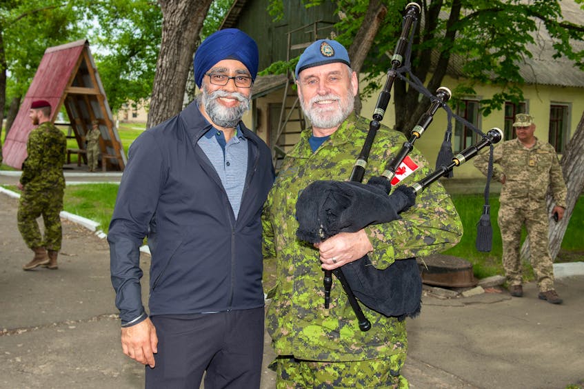 Capt. Terry Hunter, right, of Charlottetown poses with National Defence Minister Harjit Singh Sajjan at the Desna Training Centre in Ukraine in May. Photo special to The Guardian by aviator Stephanie Labossiere, Joint Task Force-Ukraine.