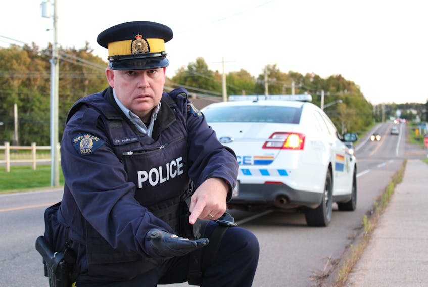 Const. Jamie Parsons finds some of the many cigarette butts littered along the streets of Stratford. He often sees drivers flicking them out of their cars at intersections, he said.
