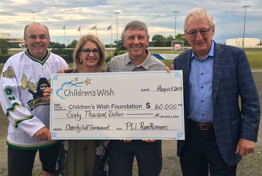 Beth Corney Gauthier, director of Children’s Wish on P.E.I., receives a $60,000 cheque from the P.E.I. RumRunners. Committee members presenting the cheque were Wayne Stewart, left, Dennis Carmichael, and George Rogers. Jennifer Gillis photo.