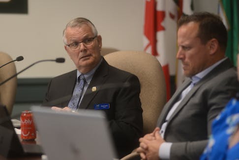 Coun. Derek Smith, left, speaks while next to Coun. Darren MacDougall during Wednesday’s council meeting. Council will soon review its dangerous and unsightly premises bylaw to see if it can be improved to allow for quicker action, especially with ticks seemingly on the rise in P.E.I.