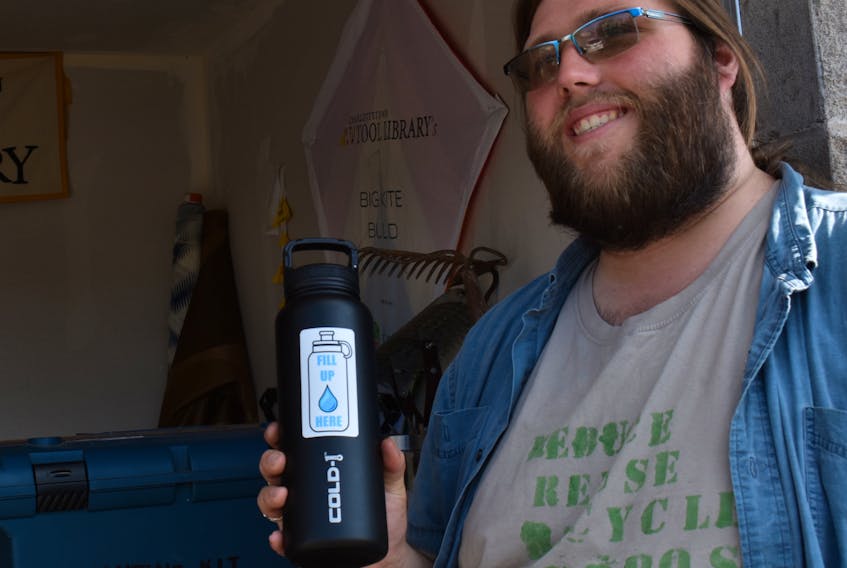Daniel Cousins shows the Fill Up Here sticker on his water bottle, which allows him to get the bottle filled free of charge at a growing number of P.E.I. businesses. Cousins started the campaign after noticing how many single use water bottles were unearthed by the melting snow in the spring.