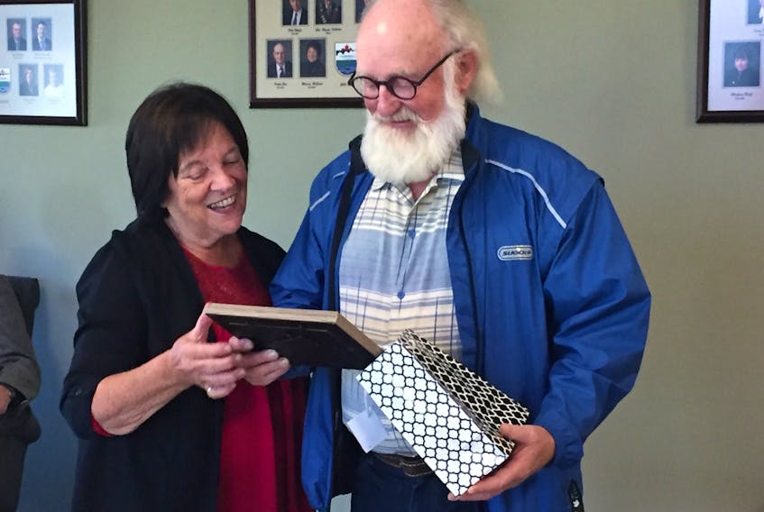 Cornwall Mayor Minerva McCourt presents a small token of thanks to Bill Hogg for his work in the community, especially his work around the new Terry Fox Sports Complex, its Naturalization Gallery and a 1.8 kilometre unnamed trail, lined with Acadian forest trees.