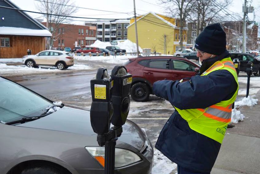 Wayne MacKay, who is with the Corps of Commissionaires, makes the rounds in downtown Charlottetown on Monday morning. For the first time in more than a month, people have to pay to park at the meters. In late November, the provincial government wrote the city a cheque for $15,000 to help cover the cost of providing on-street parking for free, Dec. 1-31.