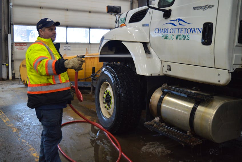 Dean Bradley, who works at Charlottetown’s public works garage on MacAleer Drive, hoses his truck down after being out on messy roads on Friday. Conditions are pretty cramped in the few bays public works has, but that’s all going to change thanks to the $3 million in the city’s capital budget to build a new 12,000-square-foot-building that will house departments currently sharing the space with public works. Dave Stewart/The Guardian