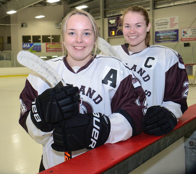 Jacy McMillan, left, and Emma Dixon play hockey for the Holland College Hurricanes.