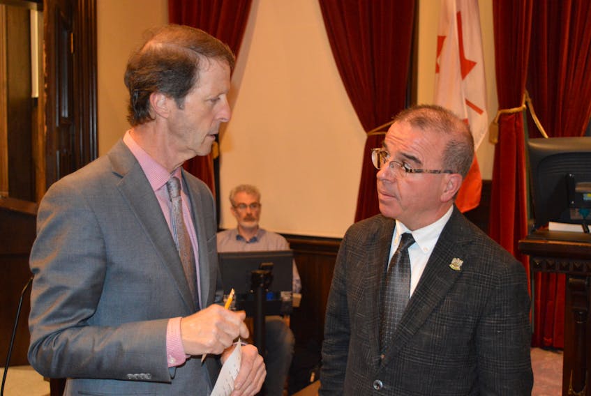 Charlottetown’s council advisory committee served notion of motion on Tuesday to propose amendments to the procedural bylaw that would give Mayor Philip Brown, right, the authority to limit the time councillors speak to a question at council meetings and presenting/speaking at public meetings. Brown is pictured talking to chief administrative officer Peter Kelly prior to Tuesday’s public council meeting.