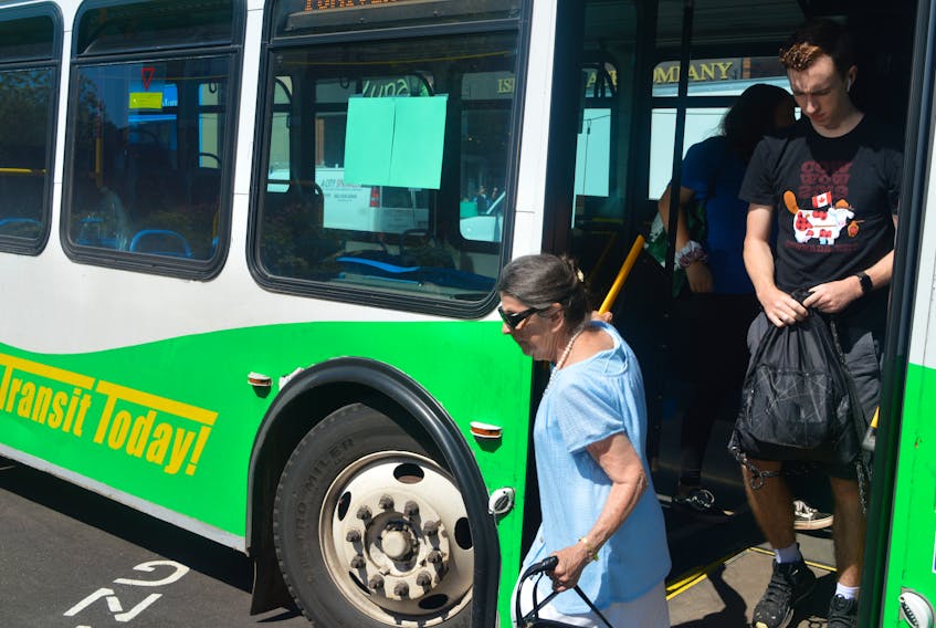 Passengers get off the bus on Grafton Street in Charlottetown on Wednesday. While funding was recently announced for six new diesel buses for T3 Transit, the City of Charlottetown says it is interested in converting over to electric buses in the future.