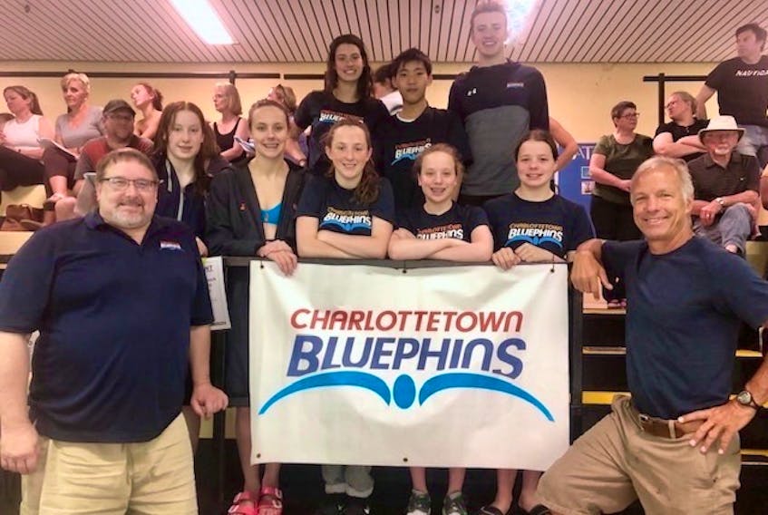 Charlottetown Bluephins on deck at Ken Dunn swim championships in Halifax, front row, from left, are head coach Tom Ponting and Swim P.E.I.’s high-performance coach Pierre LaFontaine. Second row, Courtney McBride, Amy Wheatley, Lily Robichaud-MacLeod, Elena LeClair and Holly Nickerson. Third row, Alexa McQuaid, Hercules Cheng and Charlie Morse.