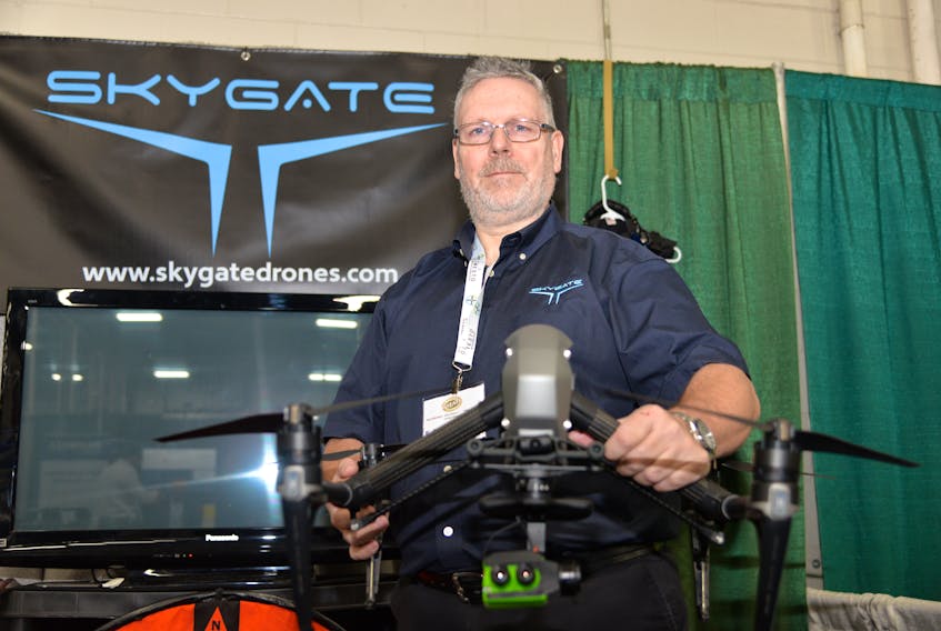 Lee Dodson, CEO of Skygate Drone Services, holds his drone equipped with a multispectral crop imaging sensor (green device at the bottom) at this year's International Potato Technology Expo.