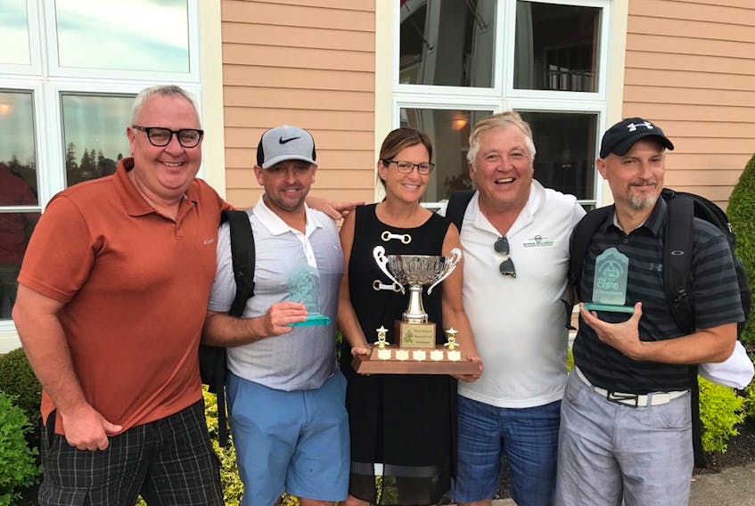 Dr. Mireille Lecours, honorary chairwoman of the 11th annual Brian McGuire Memorial Golf Tournament (The Onion), presents the trophy to the winning team from The Mount. From left, Paul Jenkins, Jason MacDonald, Lecours, Terry Hashimoto and Shawn MacIsaac.