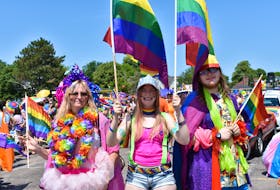 Ivory Jansen, left, waits with her mom Angel and brother Drake for the Charlottetown Pride Parade to start on Saturday. - Michael Robar
