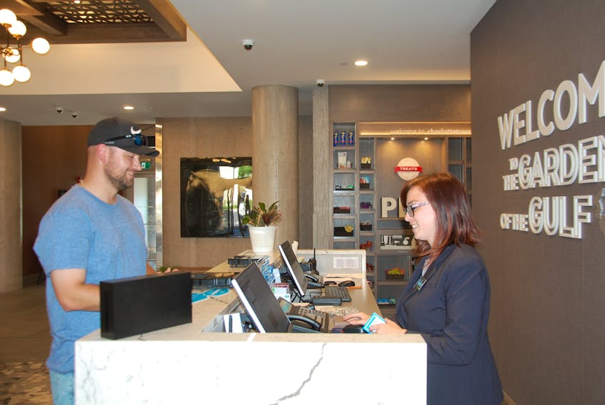 Front desk agent Amber Murphy checks Chris Curwin of Port Hope, Ont. into the Hampton Inn and Suites hotel in Charlottetown, which opened on June 27. Construction on the $15-million, six-storey hotel with 124 rooms began in the fall of 2017. The hotel, owned by the DP Murphy Group of Companies, is located on Capital Drive near the Maypoint Road roundabout. JIM DAY/THE GUARDIAN
