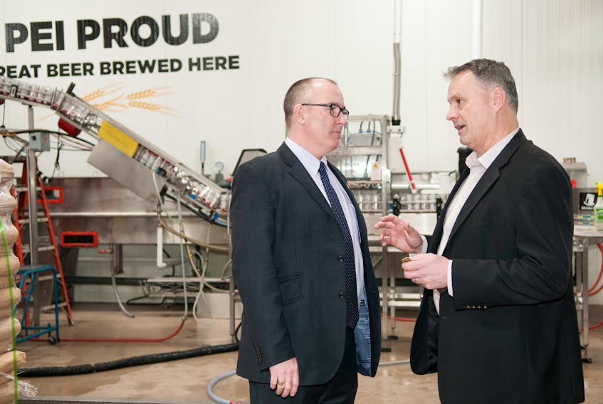 Economic Development and Tourism Minister Chris Palmer chats with P.E.I. Brewing Company president Jeff Squires on a recent visit to the company's facility in Charlottetown. The company is undertaking the second expansion to the facility in the last two years.