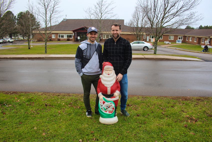Richard Rogers, left, and his husband Nick Cameron recently put out a call on social media for a light-up Santa for their home's Christmas display. Which they received. Their house faces Wedgewood Manor and they are building a display for the residents.