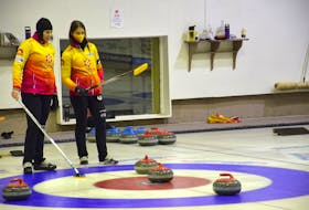 Skip Suzanne Birt, right, and Kathy O’Rourke discuss strategy during the 2021 Scotties P.E.I. women’s curling championship at the Maple Leaf Curling Club in O’Leary on Saturday. The Birt rink out of the Montague and Cornwall clubs defeated Montague’s Darlene London rink 3-0 in the best-of-five series. O’Rourke is the Birt rink’s alternate but played third stone in the provincial championship series.