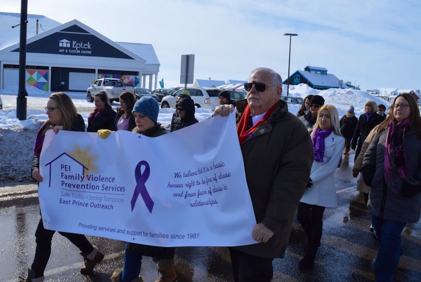 Dozens attended a walk for Family Violence Prevention in Summerside Feb. 11. Lee Anne Inman, left, and Danya O’Malley from P.E.I. Family Violence Prevention Service and Summerside Mayor Basil Stewart carried a banner that read, “We believe it is a basic human right to be free of abuse and from fear of abuse in relationships.”