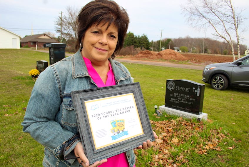 Mary Stewart, wife of the late Leo Stewart, of Summerside, holding his posthumously awarded School Bus Driver of the Year Award from the P.E.I. Home and School Federation. Leo is remembered as a fun-loving and dedicated bus driver.