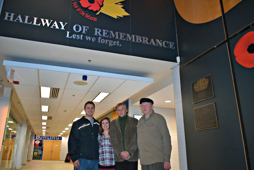 Brett Montgomery, from left, Erin Mundy, Wayne Wright, and George Dalton are on the Lest We Forget Community Veteran’s Committee Inc. The group want to ensure all veterans who served, are serving, and will yet serve, will never be forgotten. Wright created the Veterans’ Convention Centre plaque pictured on the right.
