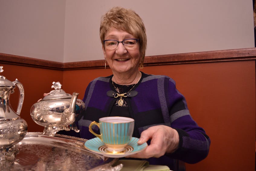 Norma Steele pours a hot cup of tea at the Mayor's Heritage Tea on Friday, Feb. 21. Steele has been pouring at the event for about 10 years.