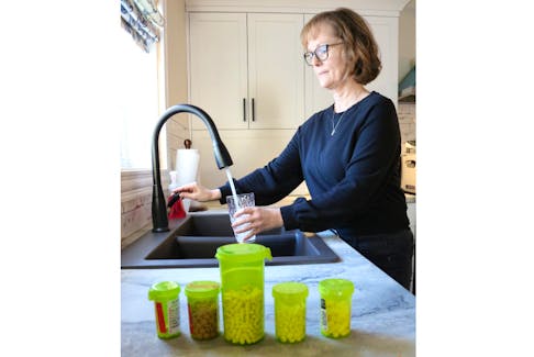 Lisa DesRoches fills a cup of water at the sink. She’s got taking her medication for Tarlov Cyst Disease down to a science. Combined with the medication she also works with a pain management doctor. The progressive, chronic disease is something she’ll live with for the rest of her life.