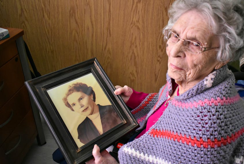 Mildred Savidant looks at a faded picture of her younger self as she reflects on the life she's led.
