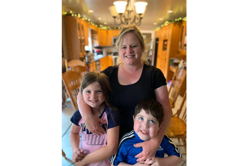 Kelly Pitre, centre, recently spent a day with her kids, Karlie and Blake, and Pitre's older brother making meat pies for their family's annual Christmas in July gathering. Submitted photo/Kelly Pitre