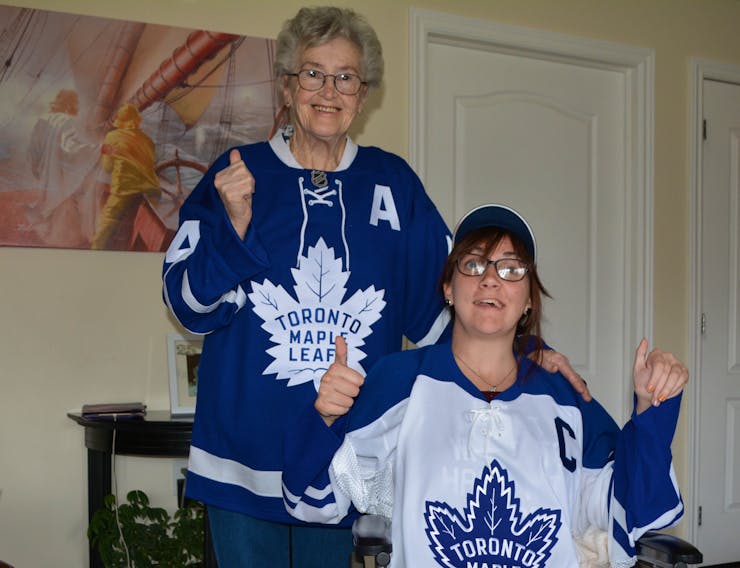 Hilda Keefe dons a borrowed Toronto Maple Leafs jersey and Bobbi-Jo LeClair proudly shows off her Doug Gilmour jersey. Keefe is the grandmother of the Toronto Maple Leafs’ new head coach, Sheldon Keefe, and LeClair is his first cousin.