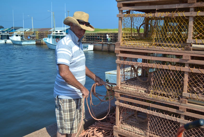Lobster boat captain Dale Hustler was pacing himself in the recent heatwave as he tied on trap lines on the wharf in Miminegash. Hustler, who has fished lobster for 52 years, is getting his gear ready for the fall season in Lobster Fishing Area 25 which is set to start on Aug. 8.