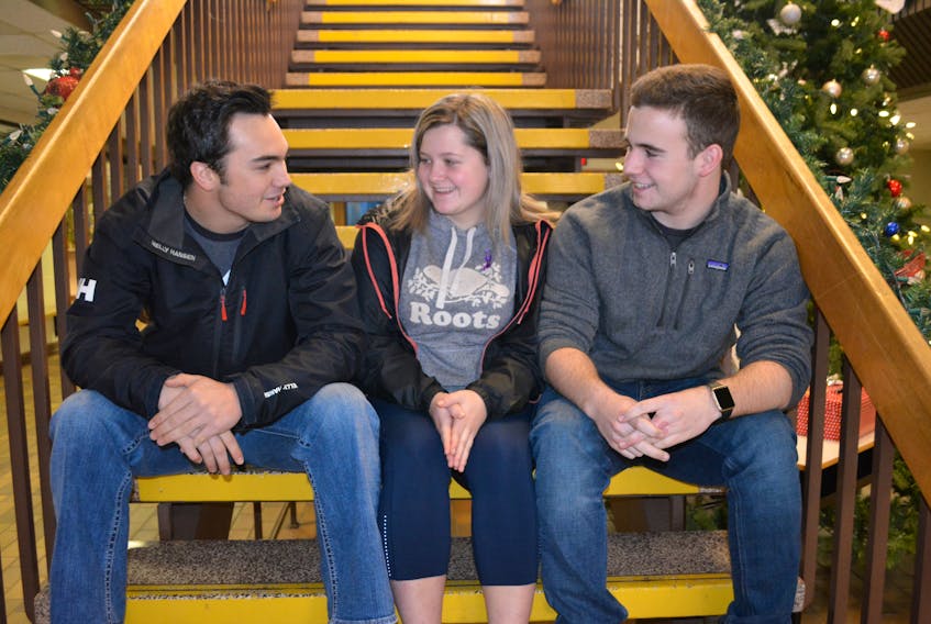 Brayden McGuigan, left, hears the details of a bottle drive in support of fellow Westisle Grade 12 student Jayden Gaudet and his family from Kloe Wilson and Nicholas Handrahan, members of the Westisle Global Issues team that is spearheading the initiative.