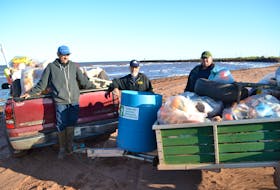 Roseville/Miminegash Watersheds Association Inc. workers, from left, Milton Chaisson, Thane Doucette and Danny Murphy display the debris their September beach sweep netted.
