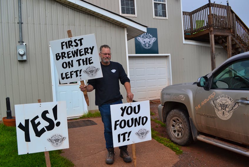 Eric Wagner displays some of the small signs that normally point the way to his Moth Lane Brewing Company down the Mickey Allen Shore Road in Freeland. He’s been so busy that he hasn’t had a chance to stick them back up following hurricane Dorian. The signs, normally located on the very dirt road that leads to Moth Lane Brewing, are popular conversation starters.