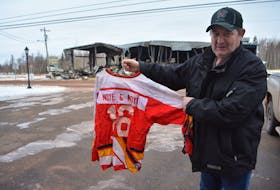 William Bishop, chief of the Tyne Valley Fire Department, holds up the only hockey jersey salvaged from the Tyne Valley rink fire. He describes the loss, just across the road from the fire hall, as “disheartening.”
Eric McCarthy/Journal Pioneer