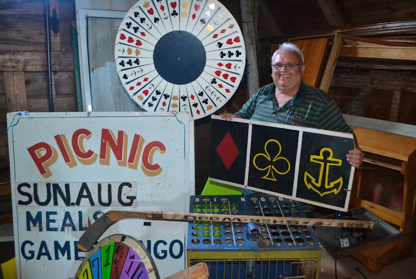 Dennis Gallant, coordinator of the St. Anthony’s Parish Picnic, takes the bingo machine and games wheels out of storage as final preparations get underway for Sunday’s picnic in Woodstock. The St. Anthony’s Parish Picnic has a rich tradition as a homecoming event, with many families planning their summer vacations around it.