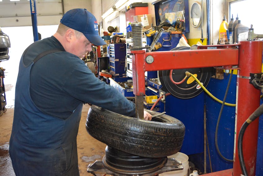 Stephen LeClair breaks a summer tire from the rim as he prepares to replace it with a studded winter tire. LeClair’s Tire and Automotive shop had been busy with tire changes all last week, but Thursday night’s snowfall shifted the process into high gear.