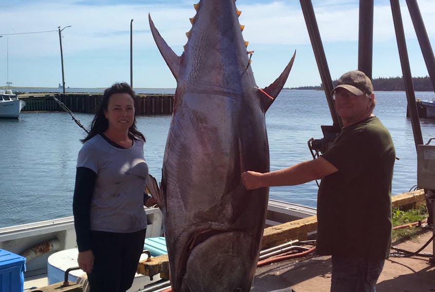 Captain Blair Matthew and his daughter Jody Gaudet pose with the 600-pound tuna they delivered to the scales in Northport Wednesday morning.
Photo by Sarah Woodside, crewmember.