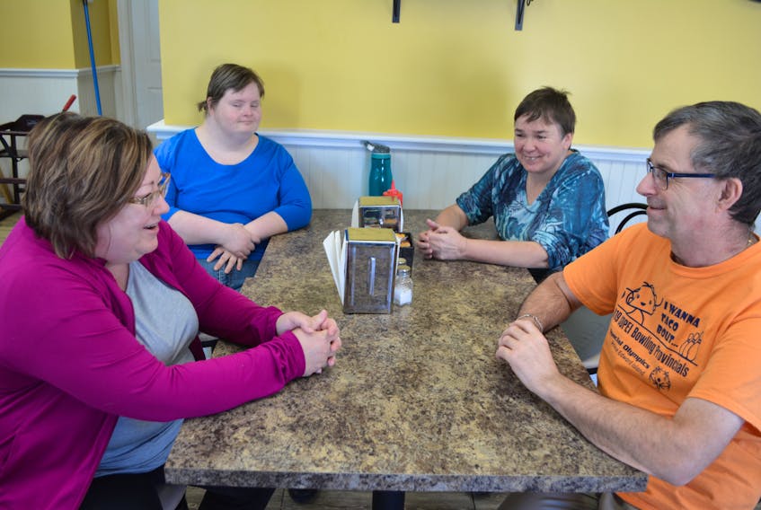 Stacie Gallant, seated front left, manager of Maple House Bakery and Café, chats with Community Inclusions' Maple House clients, Lisa Arsenault, Christine Buote and Wayne Oulton. Working with Maple House clients is the best part of her job, Gallant says.