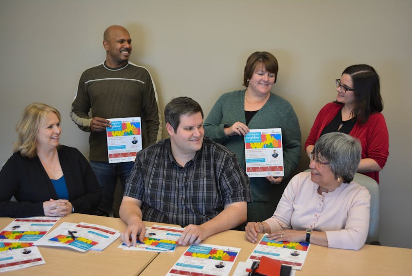 West Prince Community Navigator, Scott Smith, seated center, reviews plans for the Feb. 8 Neighbour to Neighbour event with steering committee members, seated, Maxine Rennie, left, Leti LaRosa; standing from left, Kester Nurse, Tina Richard, and Melanie Bailey.